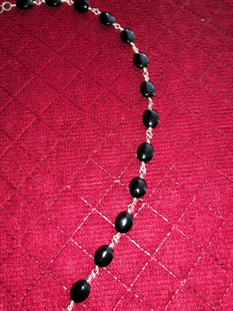 Clasp is a Silver Hook 19.5 inch Silver Wire Wrapped Onyx Bead Necklace with a 3 inch Silver and Onyx Pendent