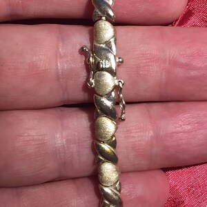 Sterling silver goldtone  ladies hinged  bracelet 7-1/2inch x and hearts 5mm wide 13.15 grams nice condition