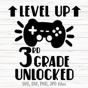 May include: Black and white graphic design with a video game controller and the text "Level Up 3rd Grade Unlocked".