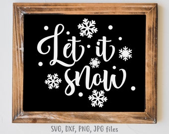May include: A framed black sign with the words "Let it snow" in white script, surrounded by white snowflakes and dots. The frame is made of brown wood. The bottom of the sign includes the text "SVG, DXF, PNG, JPG files."