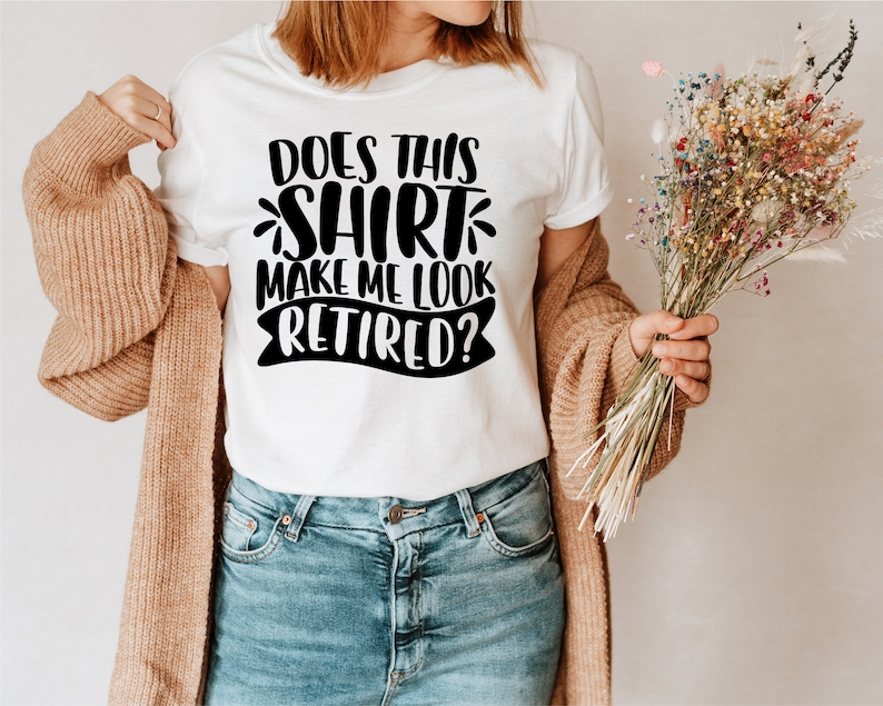 May include: White t-shirt with black text that reads "Does this shirt make me look retired?"