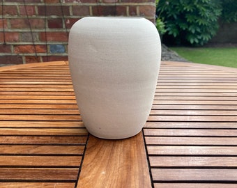 A contemporary hand made, white ceramic vase