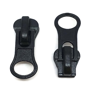 May include: Two black plastic zipper pulls with a loop at the top and a slider in the middle.
