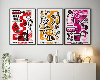 May include: Three framed illustrations of cocktails with the names Negroni, Spritz, and Americano. Each illustration is in a different color scheme: red, orange, and pink.
