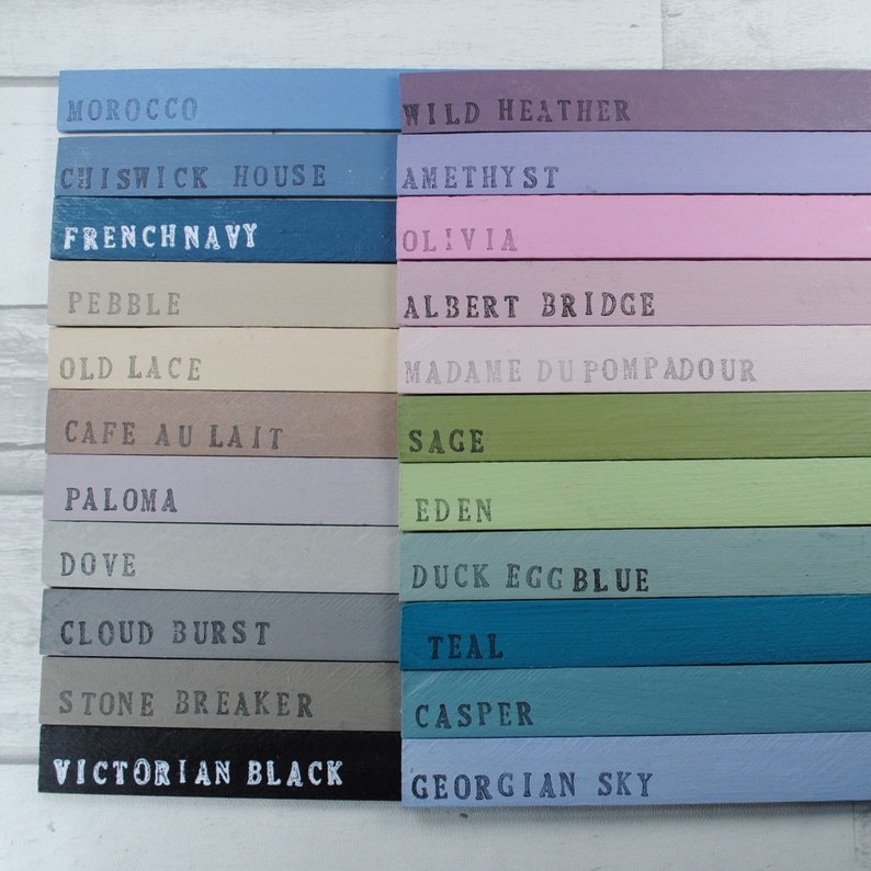 May include: A color chart with 16 paint colors, each with a name written in black text. The colors include: Moroccan, Chiswick House, French Navy, Pebble, Old Lace, Cafe au Lait, Paloma, Dove, Cloud Burst, Stone Breaker, Victorian Black, Wild Heather, Amethyst, Olivia, Albert Bridge, Madame Du Pompadour, Sage, Eden, Duck Egg Blue, Teal, Casper, and Georgian Sky.