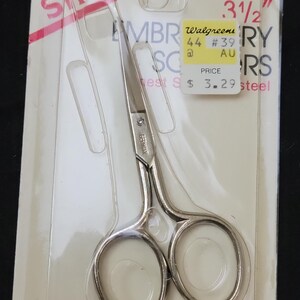 May include: Silver embroidery scissors, 3.5 inches long, in a clear plastic package. The package has the Singer logo and text that reads "Embroidery Scissors". A price tag from Walgreens is also visible.