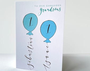 Personalised birthday card for twins, blue green hand illustrated balloons with handwritten names for twin baby boy first second birthday.