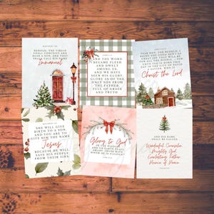 May include: A collection of Christmas-themed cards with religious quotes and festive illustrations. The cards feature text like "Immanuel," "Christ the Lord," and "Glory to God." Designs include a Christmas tree, a red door, and a snowy landscape.