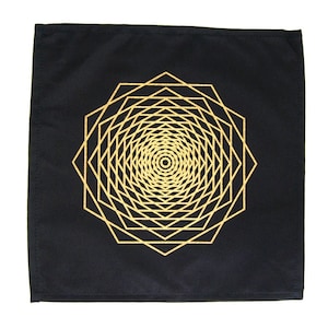 May include: Black fabric square with a gold geometric design. The design is a series of concentric octagons.
