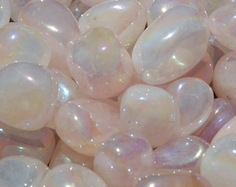 May include: A collection of iridescent, polished stones. The stones are smooth, oval-shaped, and display a range of soft colors, including white, pink, and hints of purple. The surface of each stone reflects light, creating a shimmering effect.