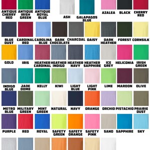 May include: A color chart displaying a variety of hues, including Antique Cherry Red, Irish Green, and Royal Blue. The text "GILDAN 2000" is at the top. The chart includes colors like Azalea, Black, and Navy.