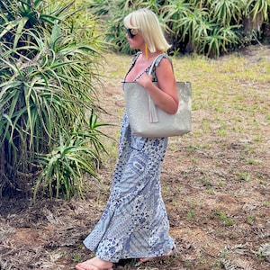 Handmade tooled leather tote bag for women with floral embossing, large zippered compartment, and boho-chic style. This personalized leather tote purse is perfect as a floral work bag or everyday handbag.