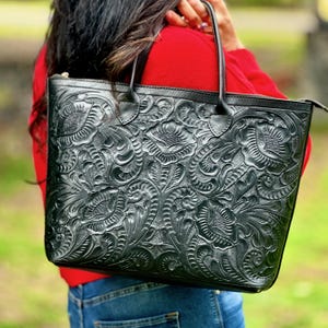 Handmade tooled leather tote bag for women with floral embossing, large zippered compartment, and boho-chic style. This personalized leather tote purse is perfect as a floral work bag or everyday handbag.
