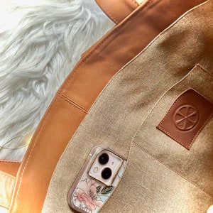 Spacious interior of leather pickleball court bag showing two main compartments and interior zipper pocket