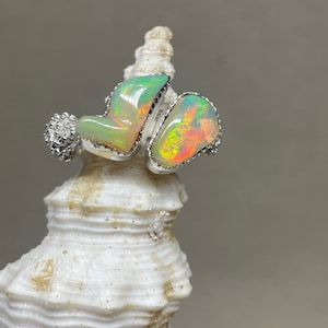 Simple yet stunning pair of Ethiopian Opals are nested together in a silver setting