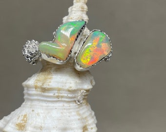 Simple yet stunning pair of Ethiopian Opals are nested together in a silver setting