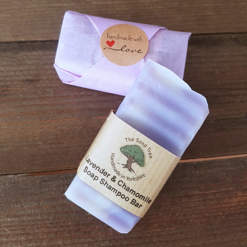 May include: A purple and white striped bar of lavender and chamomile soap shampoo, wrapped in brown paper with the text "The Soap Tree" and "Handmade in Yorkshire". The label also includes a small illustration of a tree.