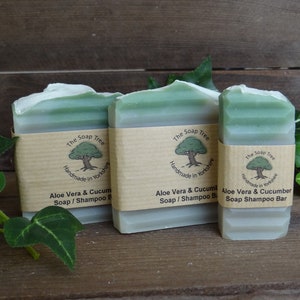 May include: Three bars of green soap with white labels. The labels have a tree logo and the text "The Soap Tree Handmade in Yorkshire Aloe Vera & Cucumber Soap/Shampoo Bar".
