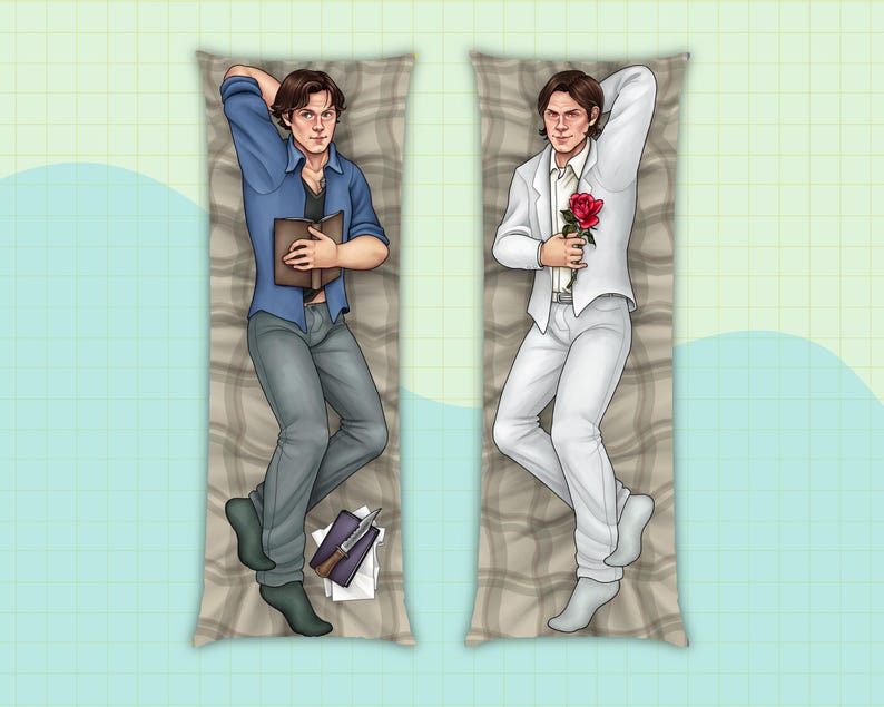 May include: Two body pillows featuring illustrations of men. One man is wearing a blue shirt and jeans and holding a book. The other man is wearing a white suit and holding a red rose.