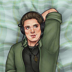 May include: A person wearing a green shirt with a black undershirt and a necklace with a pendant. They are wearing headphones and have their arm resting behind their head. The person is lying on a green and white plaid surface.