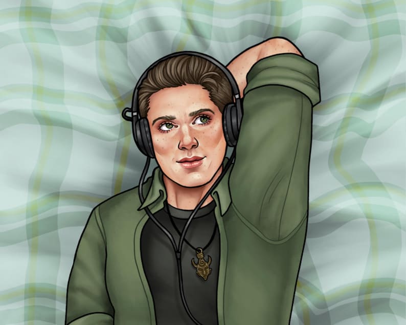 May include: A person wearing a green shirt with a black undershirt and a necklace with a pendant. They are wearing headphones and have their arm resting behind their head. The person is lying on a green and white plaid surface.