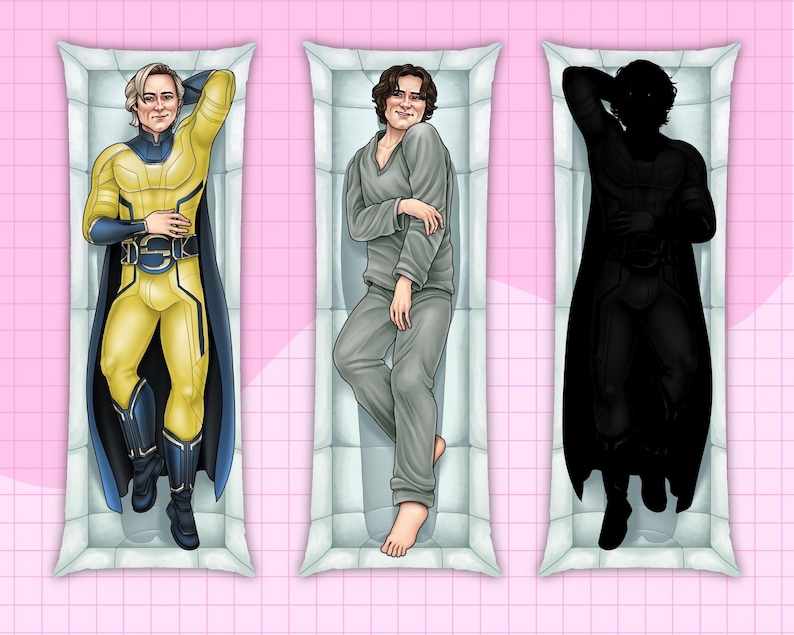 May include: Three rectangular body pillows with illustrations of figures. The first pillow features a figure in a yellow and blue superhero costume. The second pillow shows a figure in gray pajamas. The third pillow displays a black silhouette of a figure in a superhero costume.