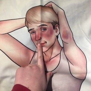 May include: A fabric print featuring a stylized illustration of a person with blonde hair and a light-colored tank top. The figure has flushed cheeks and a bruise on their elbow, with one hand raised behind their head and a finger held to their lips.