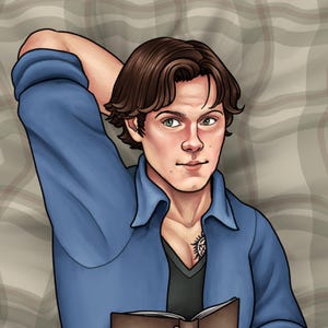 May include: A man with brown hair is lying on a plaid blanket. He is wearing a blue shirt and a black shirt underneath. He has a tattoo on his chest. He is holding a book in his hands.