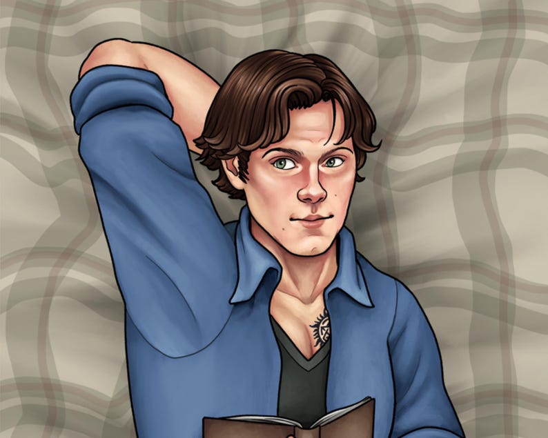May include: A man with brown hair is lying on a plaid blanket. He is wearing a blue shirt and a black shirt underneath. He has a tattoo on his chest. He is holding a book in his hands.