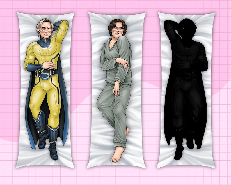 May include: Three body pillow covers featuring illustrations of figures in various poses. One is a superhero in a yellow and blue costume, another in gray pajamas, and the third is a black silhouette. The pillows are rectangular and rest on a pink grid background.