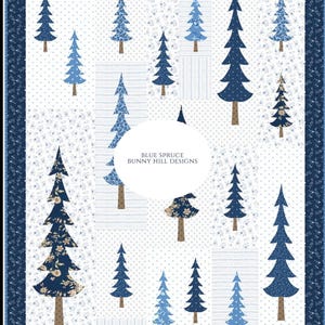 May include: A quilted blanket featuring a pattern of blue spruce trees on a white background. The trees vary in shades of blue and are set against a backdrop of white fabric with small floral and dotted patterns. The border is a dark blue floral design. The text "BLUE SPRUCE BUNNY HILL DESIGNS" is in the center.