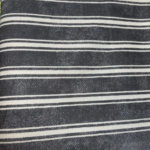 May include: Black and white striped fabric with a subtle textured pattern. The fabric has a slightly distressed look.