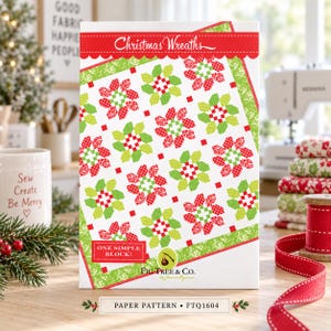 May include: A paper pattern titled Christmas Wreaths by Fig Tree & Co. featuring a quilt design with red and green floral and geometric blocks on a white background. The cover includes the text One Simple Block and the model number FTQ1604.
