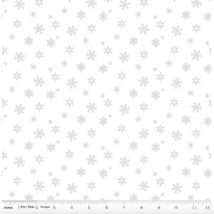 May include: White fabric with a repeating pattern of silver snowflakes in various sizes. The snowflakes are scattered across the surface, creating a wintery or holiday theme. The fabric has a ruler along the bottom edge.