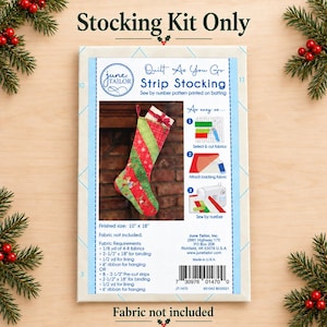May include: A June Tailor Quilt As You Go Strip Stocking kit package featuring a finished size of 10 inches by 18 inches. The packaging displays a red and green striped Christmas stocking, sewing instructions, fabric requirements, and a barcode.