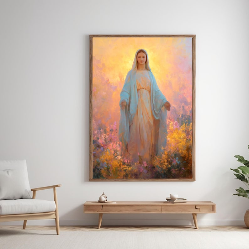 May include: A framed artwork depicts a serene figure in flowing robes, standing amidst a vibrant field of flowers. The figure is draped in light blue and cream-colored garments, with a soft, golden light emanating from behind. The artwork is displayed in a room with a wooden table and chair.