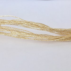 May include: A bundle of gold metallic thread, perfect for crafting and adding a touch of sparkle to projects.