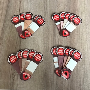 May include: Six sets of brown and white thread cards with the text "Hose Mending Handy Compact" printed on each card. The cards are arranged in a fan shape with the thread colours visible.