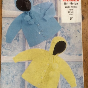 May include: A knitting pattern for a baby cardigan and hat. The pattern is for a blue cardigan with a hood and a yellow cardigan with a hood. The pattern is for sizes 20 to 24 inches chest. The pattern is from Robin Bri-Nylon Double Knitting.