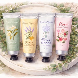 May include: Four hand cream tubes on a white tray, each labeled with a different floral scent: Gardenia, Honey Lavender, French Lavender, and Rose. The tubes are 2 oz each and are arranged with floral accents.