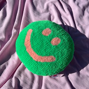 Handmade tufted bright green and peach smiley face cushion
