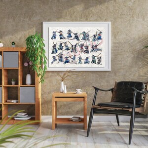 May include: A framed watercolour print depicting multiple figures in combat poses. The figures are in blue, black, and red against a textured, off-white background. The artwork is displayed in a room with wooden furniture and a plant, creating a stylish interior.