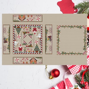 Puede incluir: Un cojín alfiletero con temática navideña con un diseño de casa de jengibre. El cojín presenta patrones de punto de cruz de hombres de jengibre, árboles de Navidad y bastones de caramelo. También es visible el texto "Merry Xmas Stitch".