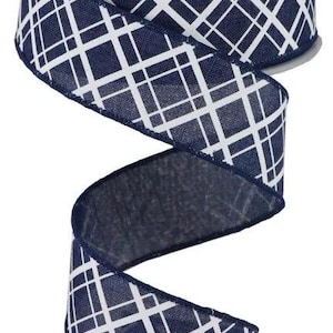 May include: A spool of navy blue ribbon with a white geometric pattern. The ribbon is made of a textured material and is unrolled, showing the pattern in detail. The ribbon is suitable for crafts, gift wrapping, and decorations.