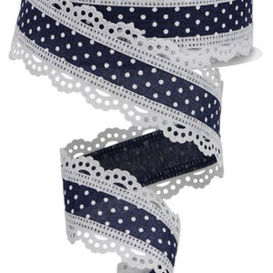 May include: White lace ribbon with a navy blue polka dot stripe. The ribbon has a scalloped edge.