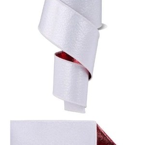 May include: A spool of Glimmer Ribbon featuring a textured white exterior and a metallic red interior. The ribbon is shown both as a coiled roll with a black label at the top and as a flat, extended strip revealing the contrasting red underside.