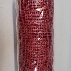 May include: A roll of red deco mesh ribbon, a type of craft supply used for decorating, wrapped in clear plastic.