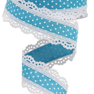 May include: Blue and white polka dot ribbon with white lace trim. The ribbon is rolled up and the lace trim is visible on the edges.