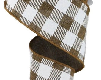 May include: A roll of decorative ribbon featuring a brown and white checkered pattern. The ribbon has a brown edge and is ideal for crafts, gift wrapping, or seasonal decor. The ribbon is approximately 2.5 inches wide.