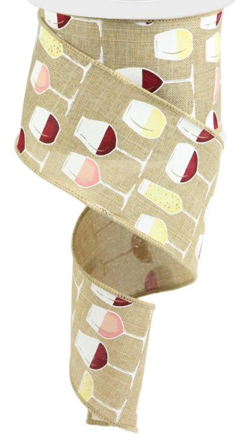 May include: A tan-colored wired ribbon featuring a repeating pattern of wine glasses filled with red, white, and sparkling wine. The fabric has a visible woven texture, and the edges are finished with a stitched border to maintain its shape.